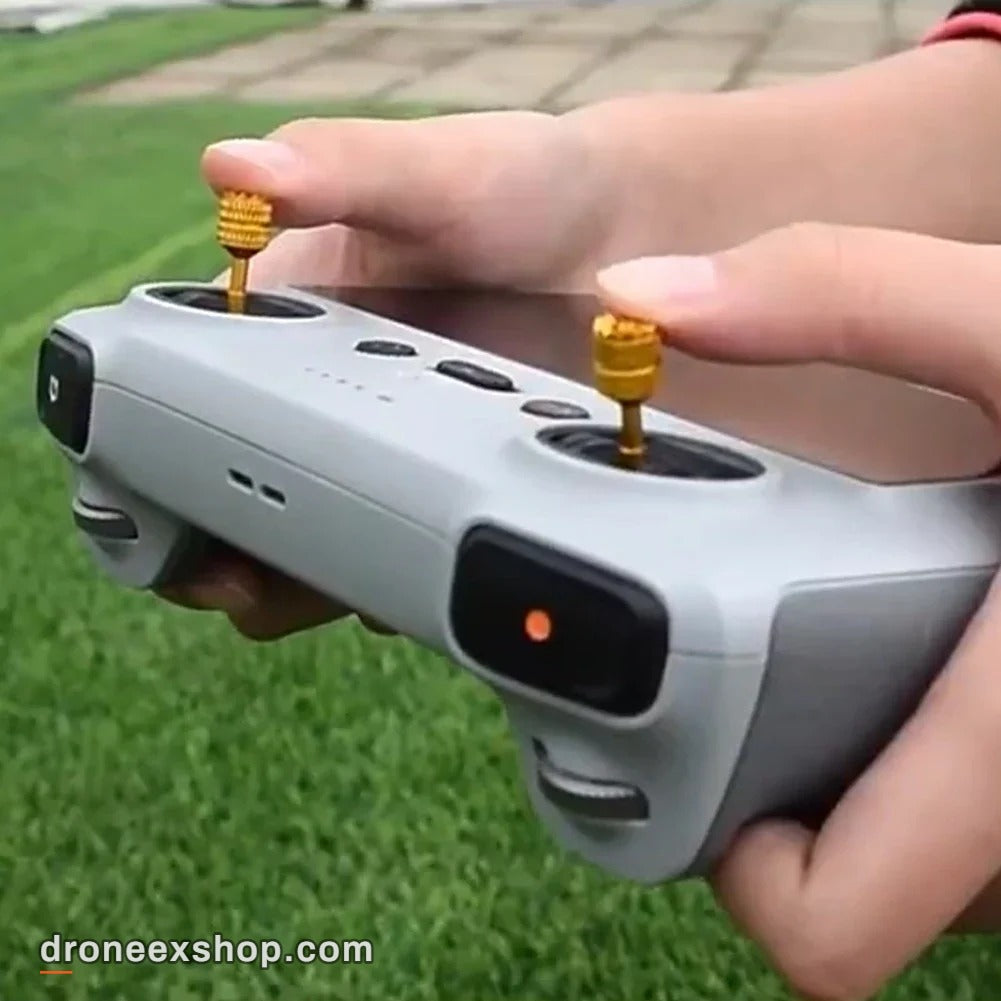 Yellow thumb sticks fitted on a DJI remote controller